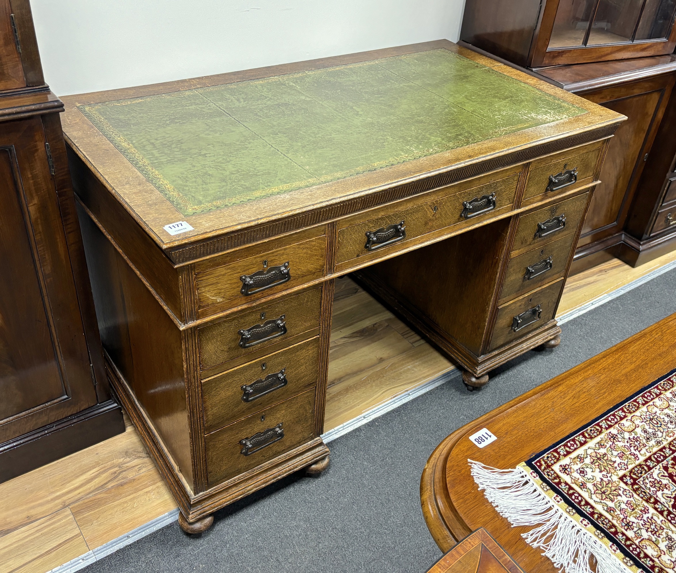 An early 20th century oak pedestal desk, width 123cm, depth 69cm, height 76cm